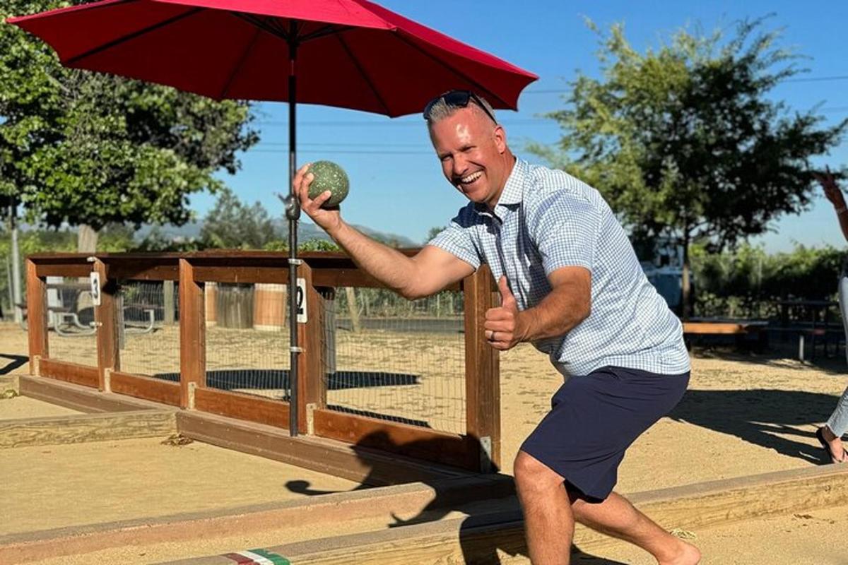 a man holding a ball and an umbrella