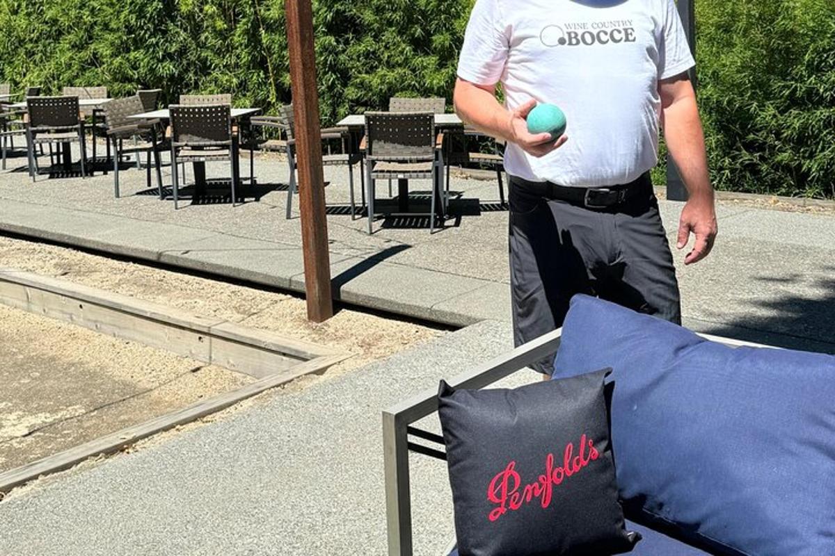 a man holding a ball in front of a table