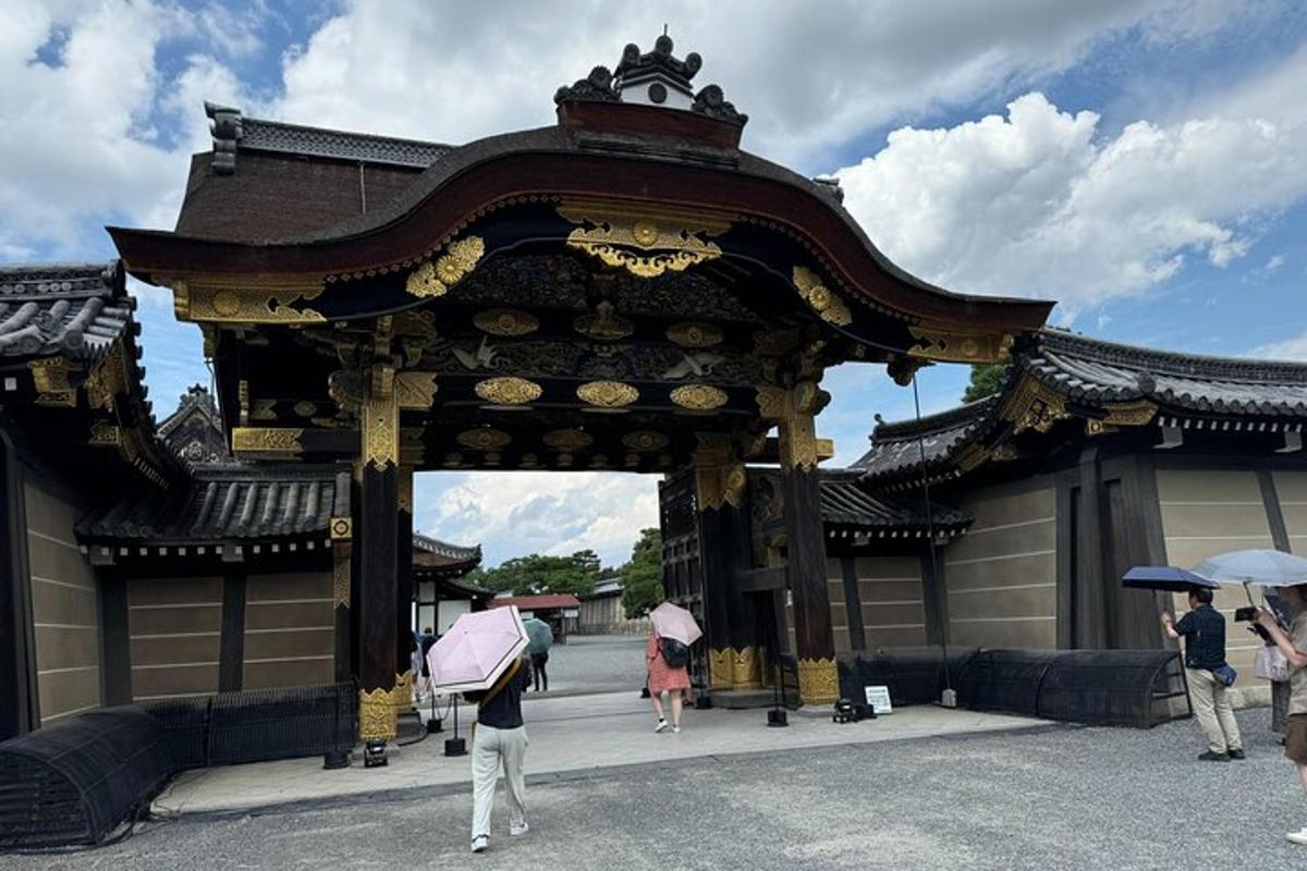 a group of people with umbrellas standing in front of a gate