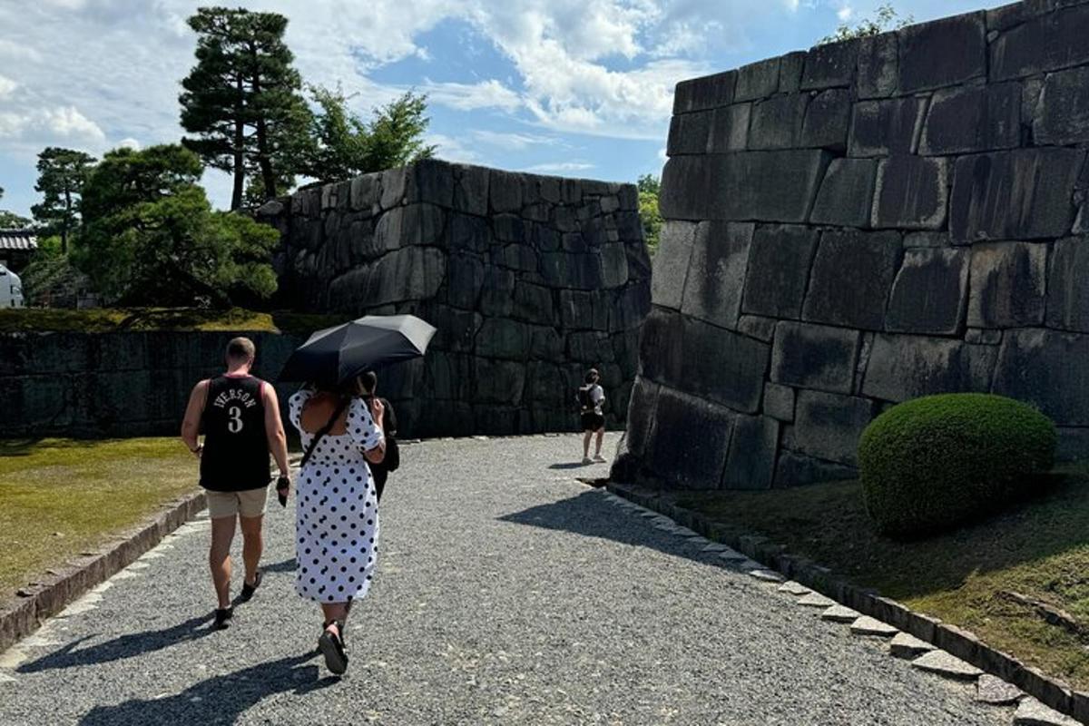 a man and woman walking down a path with an umbrella