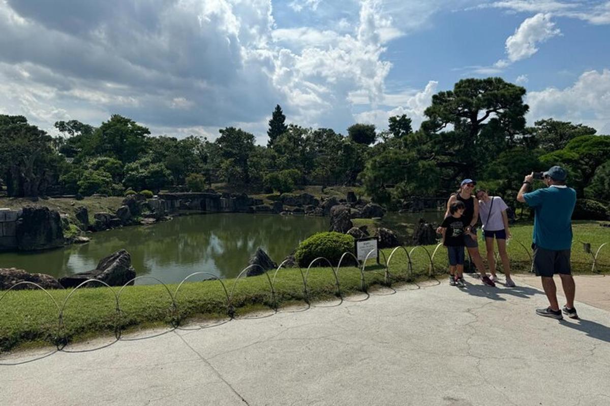 a group of people taking a picture of a pond