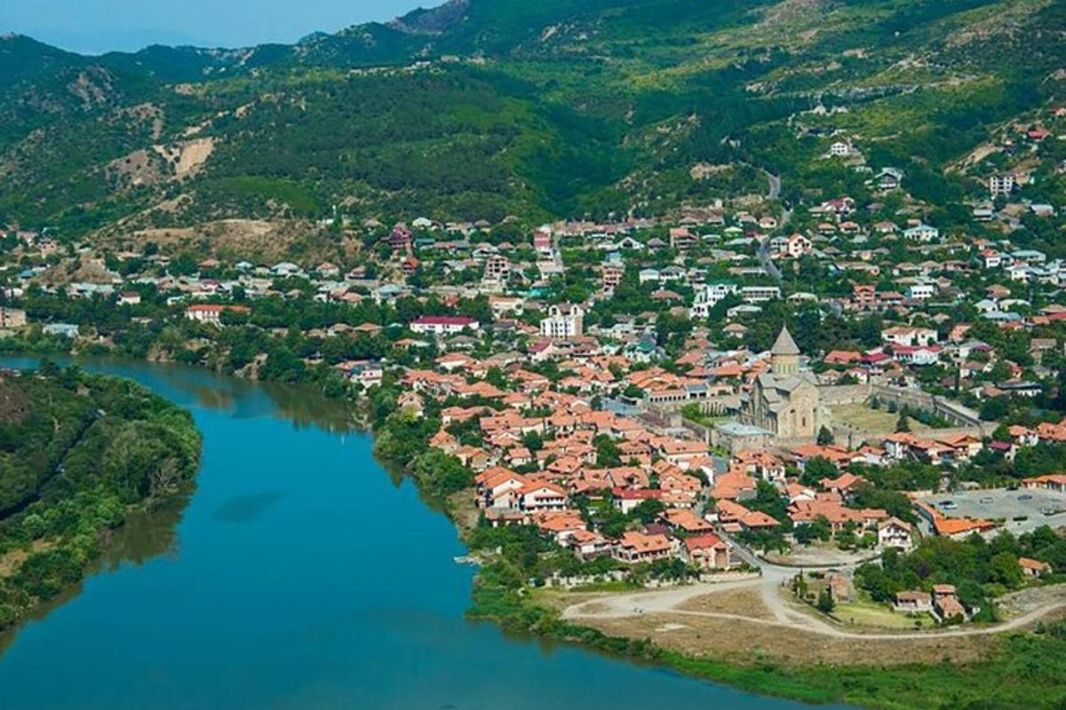 an aerial view of a town next to a river