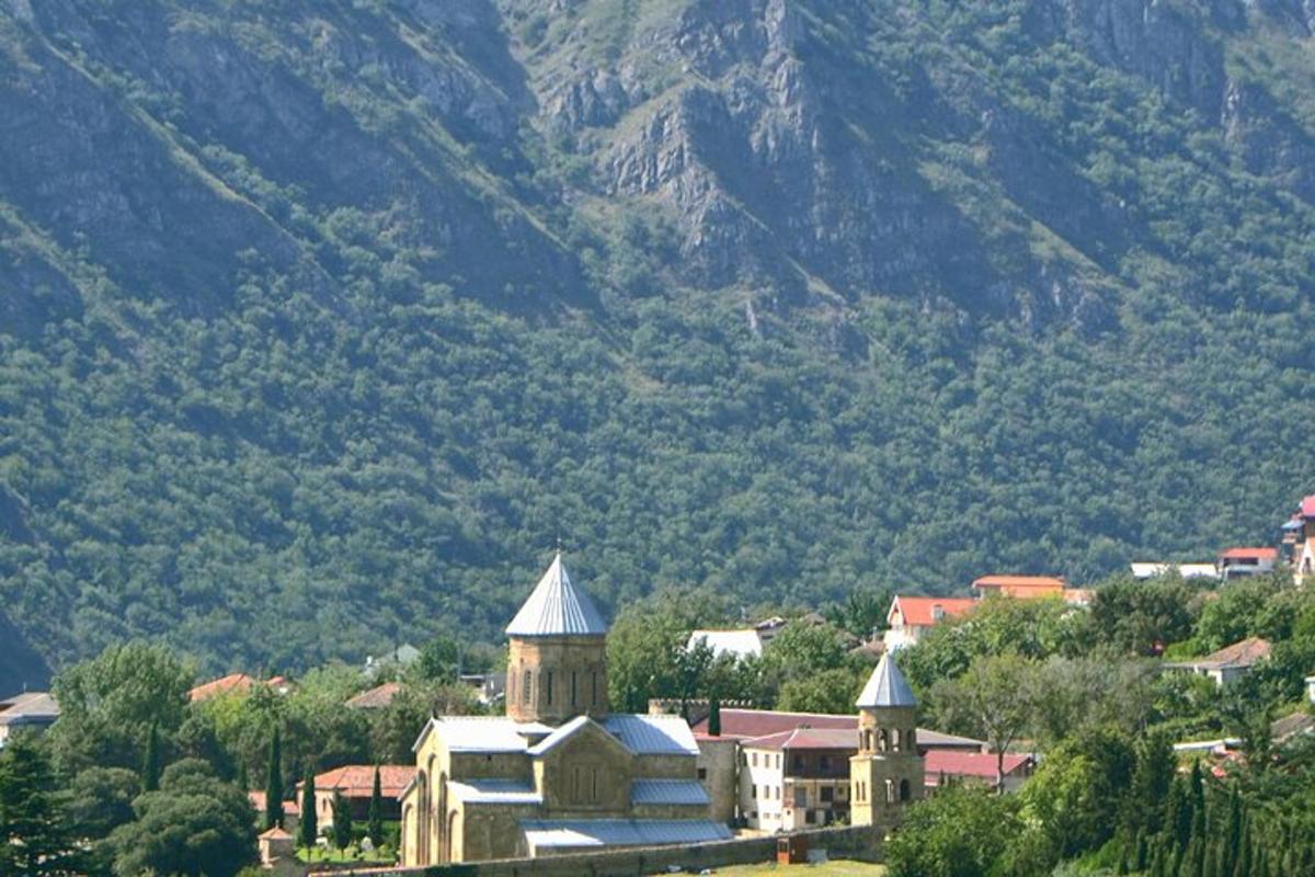 a small town with a building and a mountain