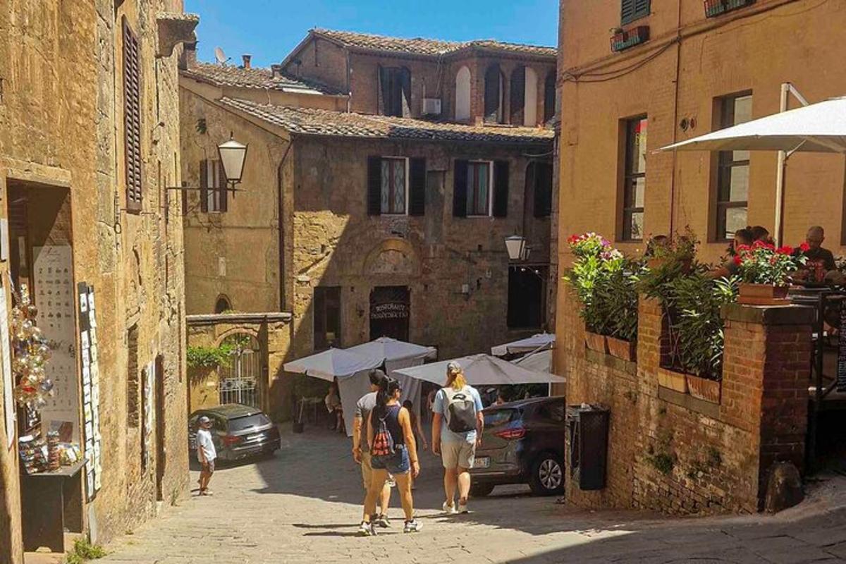 a group of people walking down a street with umbrellas