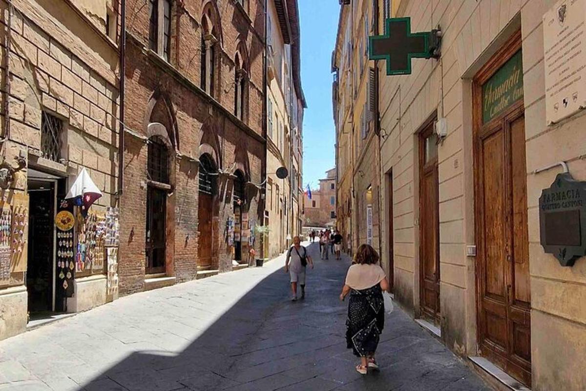 a woman walking down a street in an alley