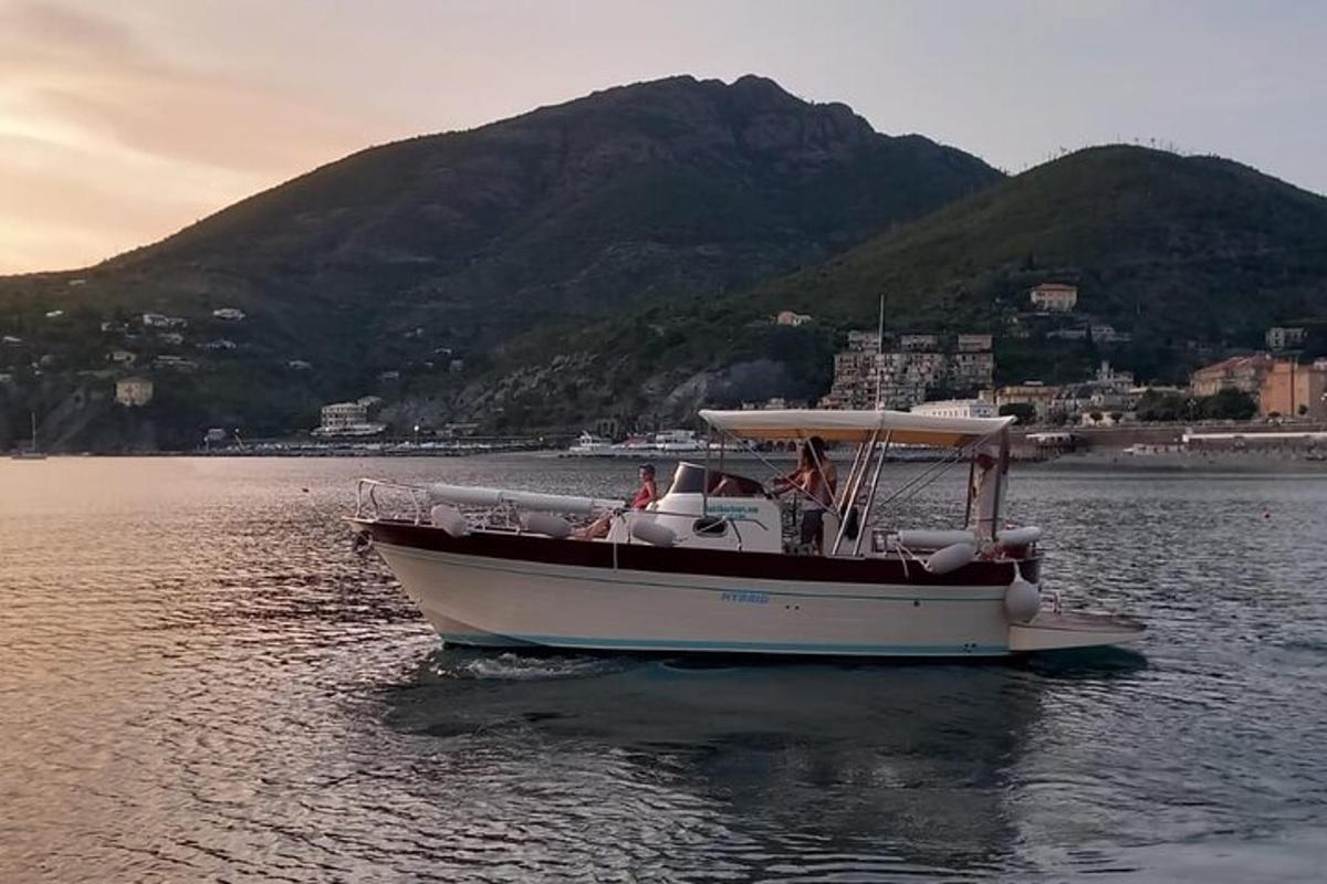 a boat in the water with a mountain in the background