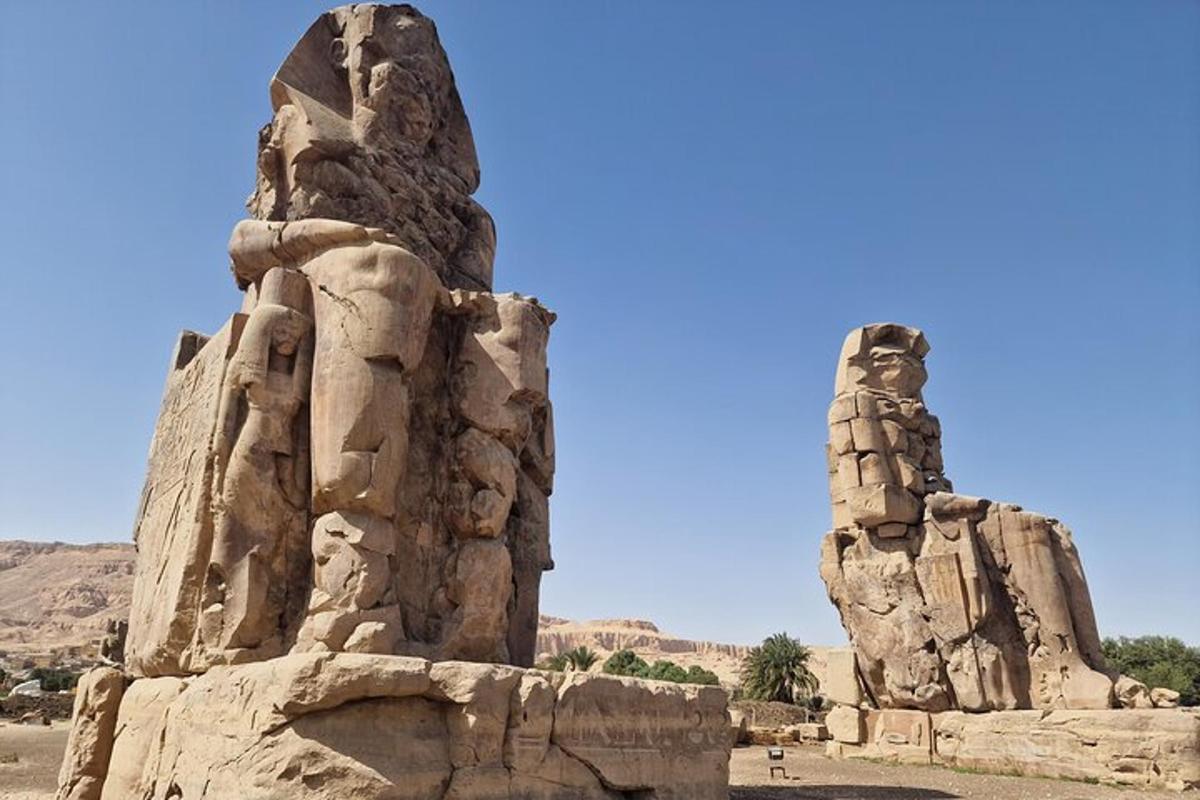 a stone building with a pillar in the desert