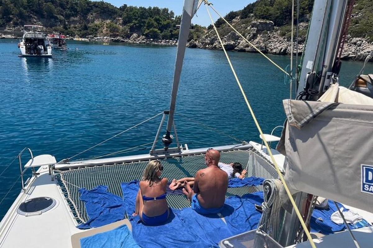 a man and a woman sitting on the deck of a boat