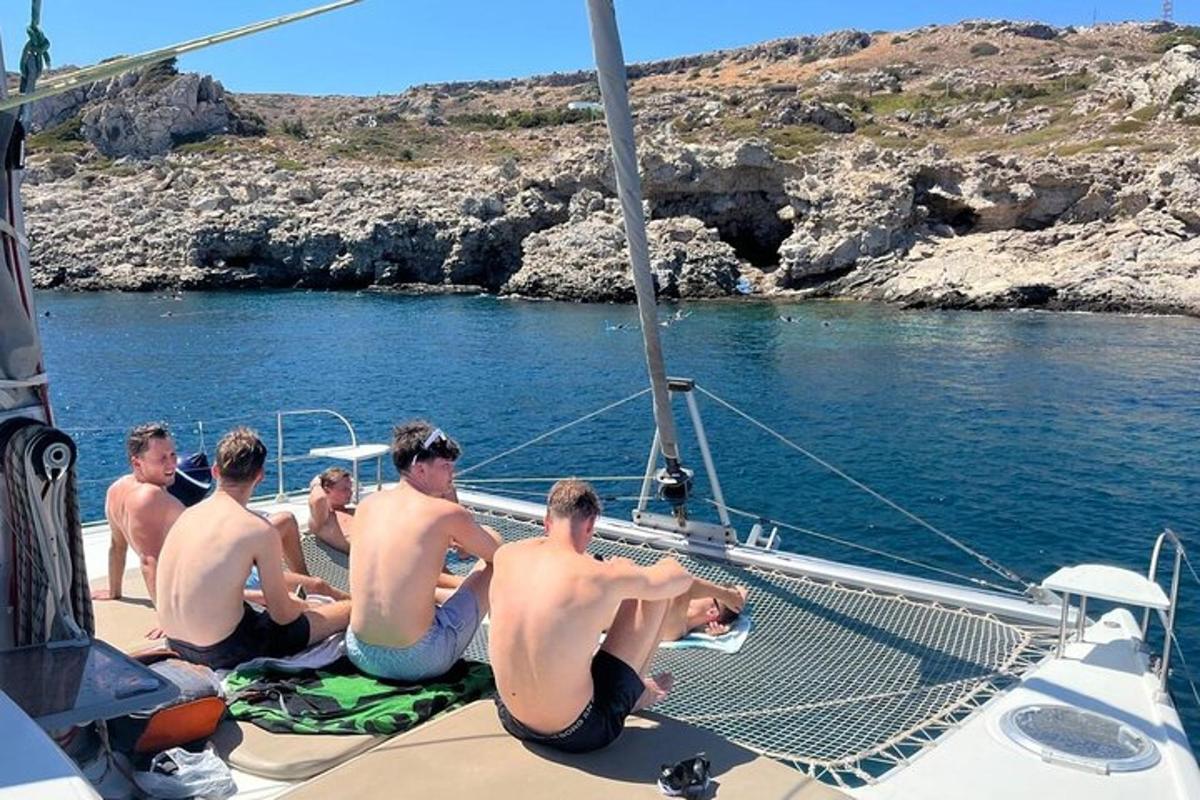a group of men sitting on the deck of a boat