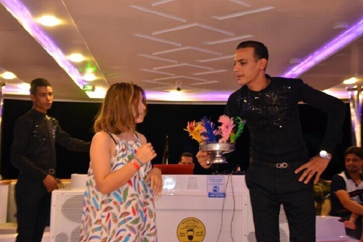 a man and a woman standing in front of a table