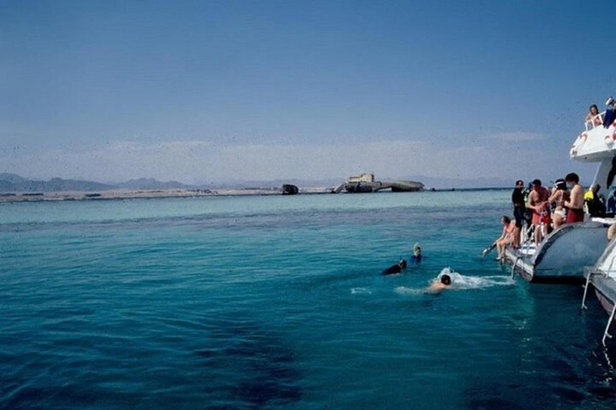 un gruppo di persone in acqua accanto a una barca