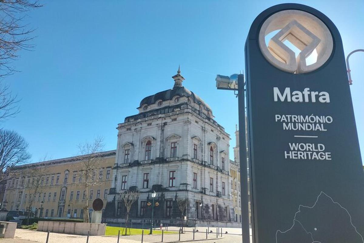 a sign in front of a large building