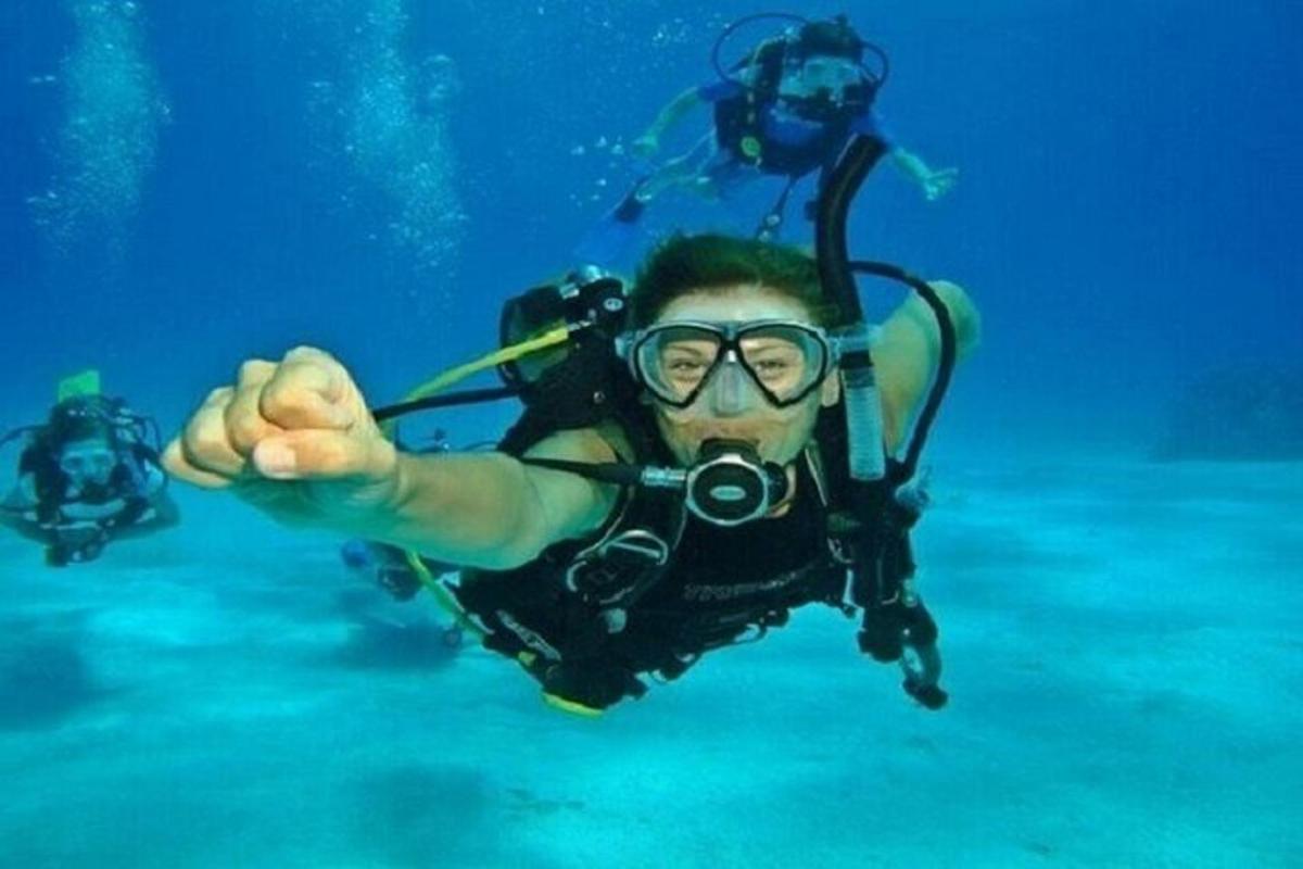 a man in a diving suit and glasses is in the water