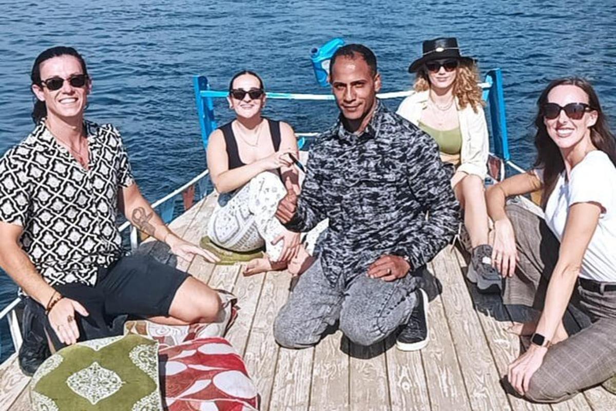 a group of people sitting on a boat on the water
