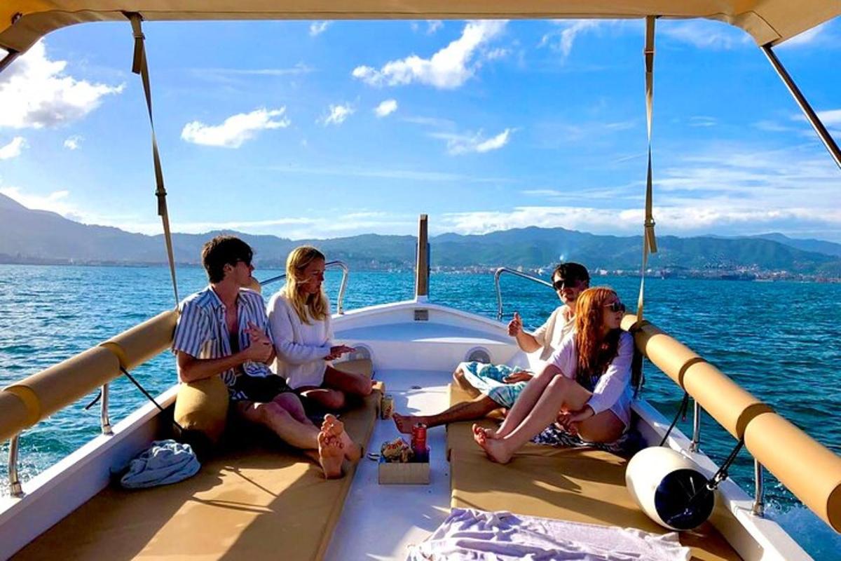 a group of people sitting on the bow of a boat