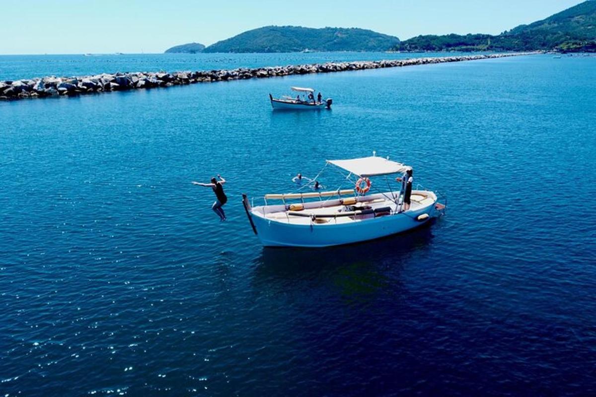a person jumping off of a boat in the water
