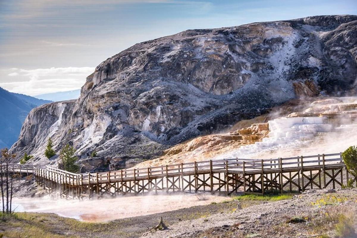 a wooden bridge in front of a mountain