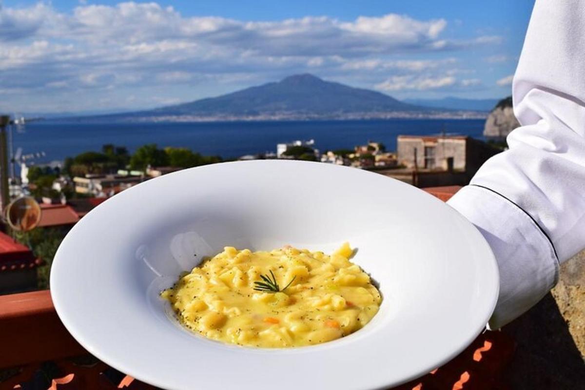 a person holding a white bowl of macaroni and cheese