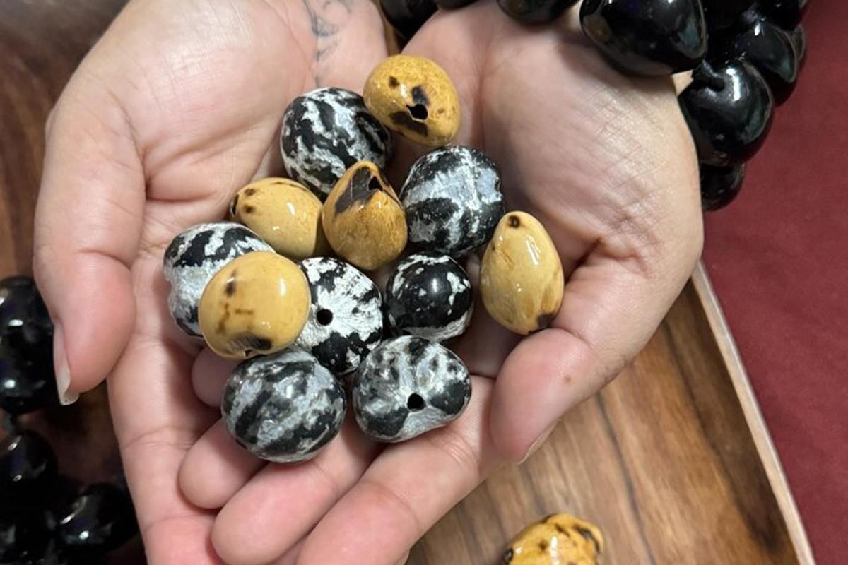 a person holding a handful of quail eggs