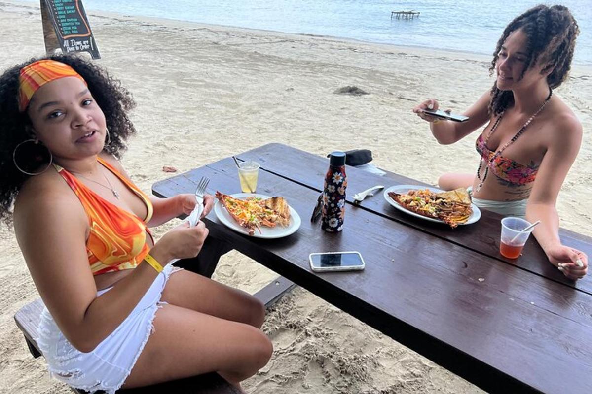 dve dievčatá sediace za piknikovým stolom na pláži
