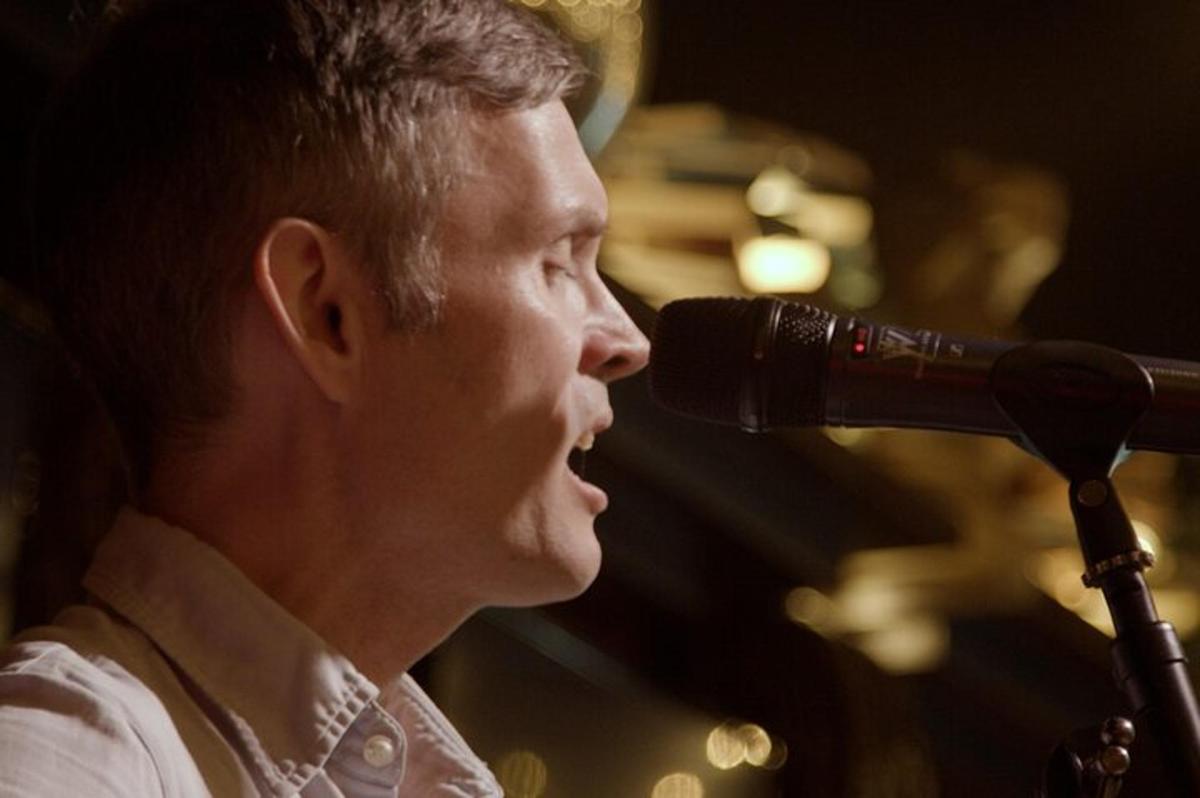 a man is singing into a microphone
