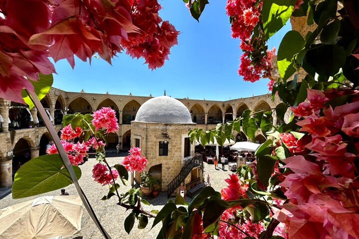 un cortile con fiori rosa di fronte a un edificio