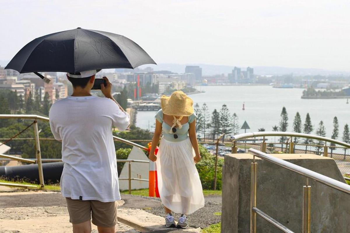 a man taking a picture of a woman with an umbrella
