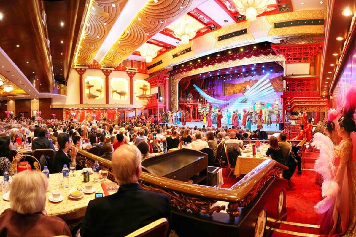 a large crowd of people sitting in a large auditorium