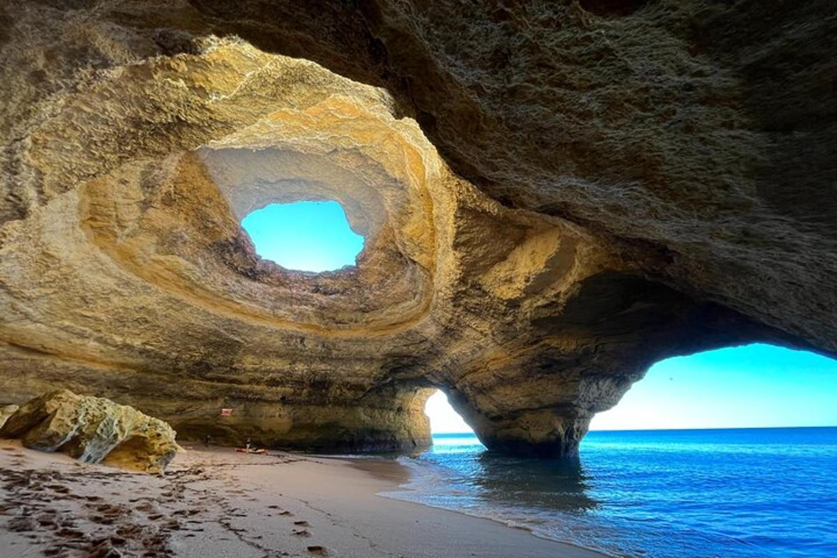 a large rock formation on a beach with the ocean