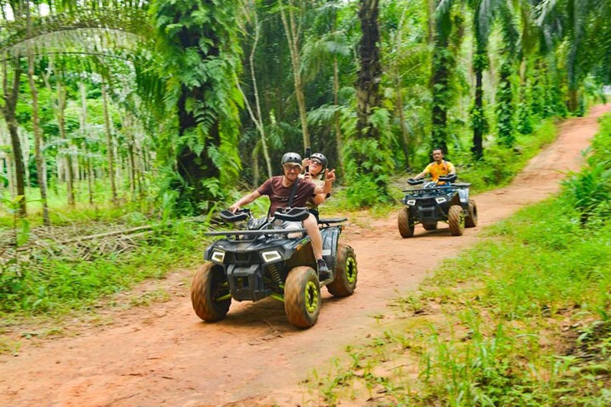 two people riding atvs on a dirt road