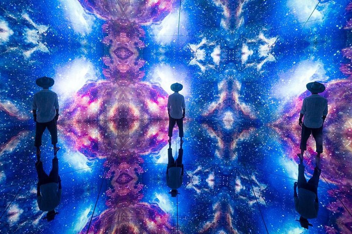 a group of people standing in front of a universe