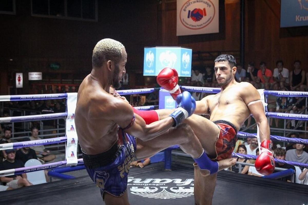 two men are fighting in a boxing match
