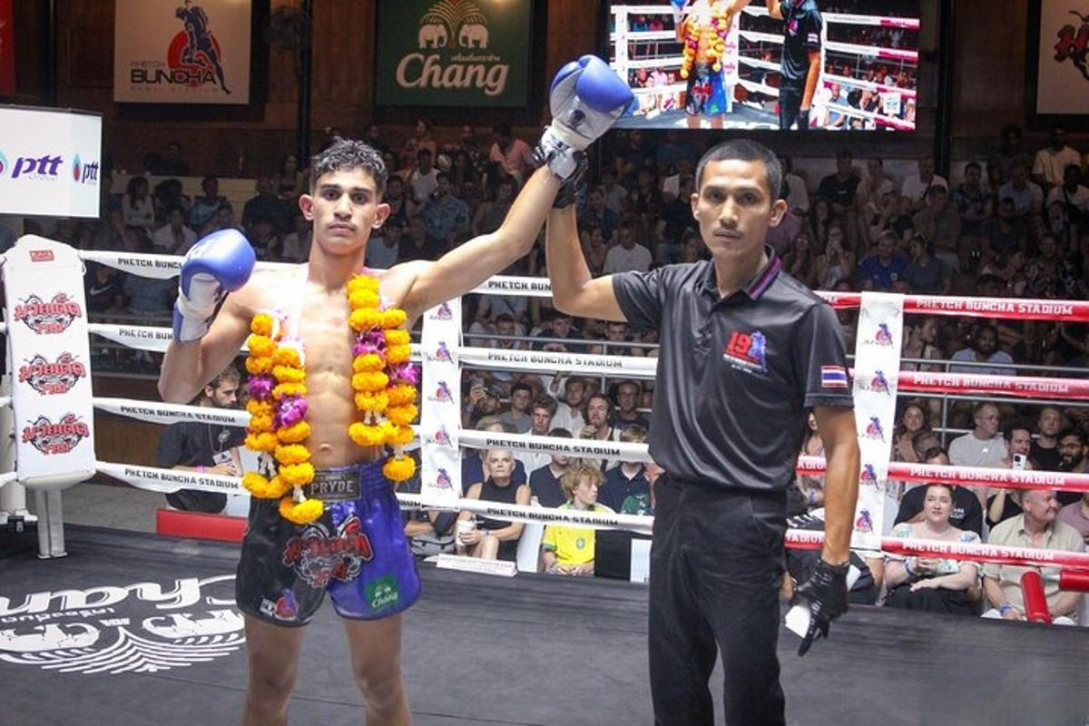 two men standing in a boxing ring with boxing gloves
