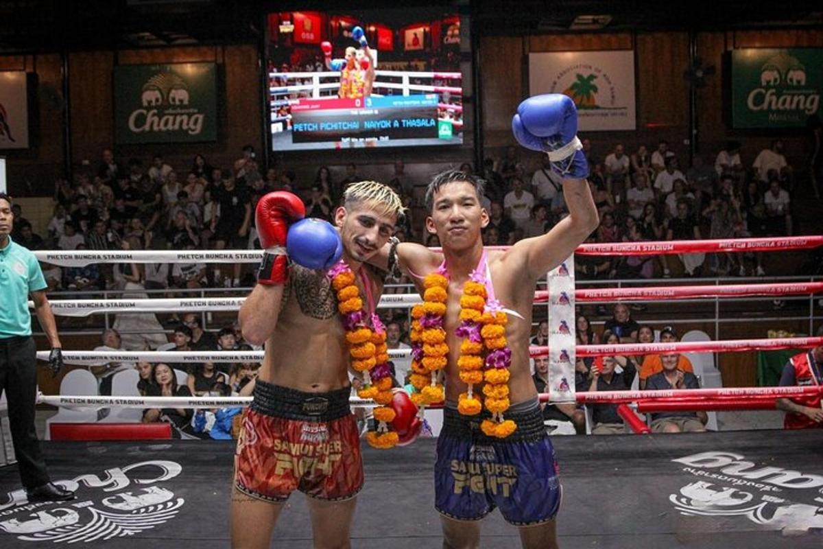 two men are standing in a boxing match