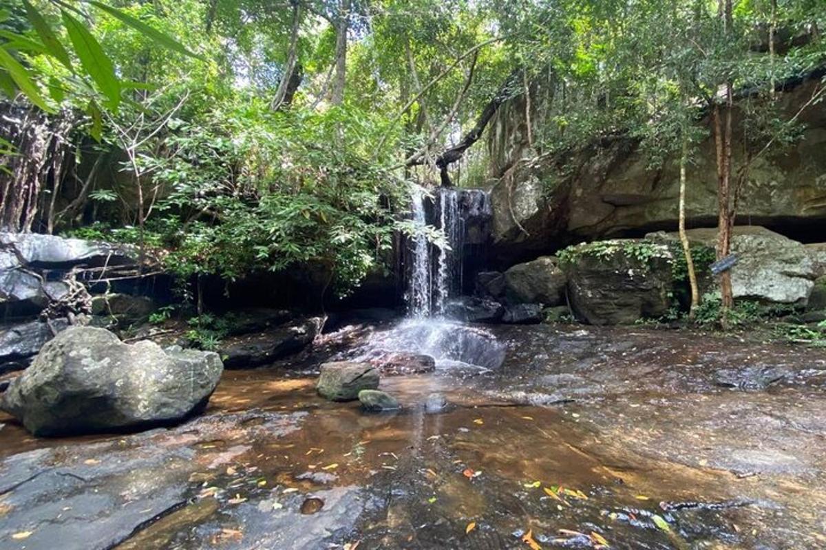 a waterfall in the middle of a river with rocks