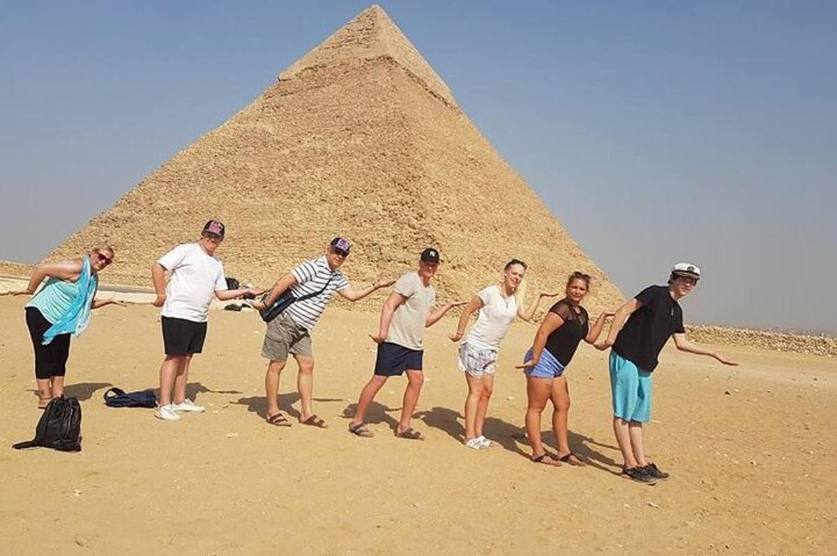 a group of people standing in front of the pyramid