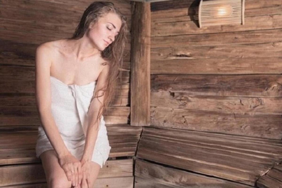 una donna in abito bianco seduta in una stanza