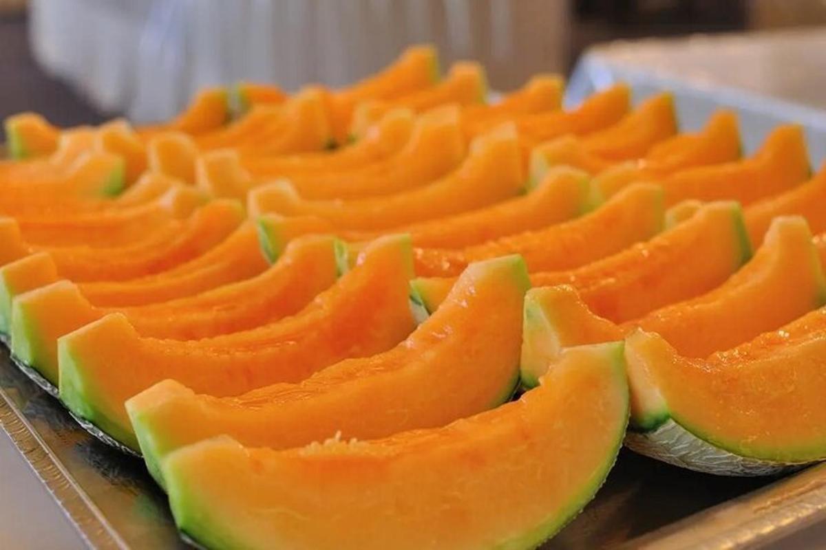 a bunch of orange fruit on a tray