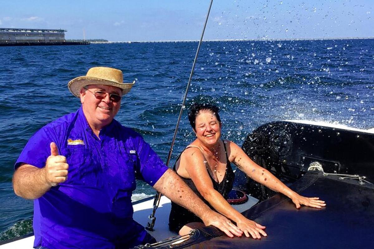 a man and woman sitting on a boat in the water