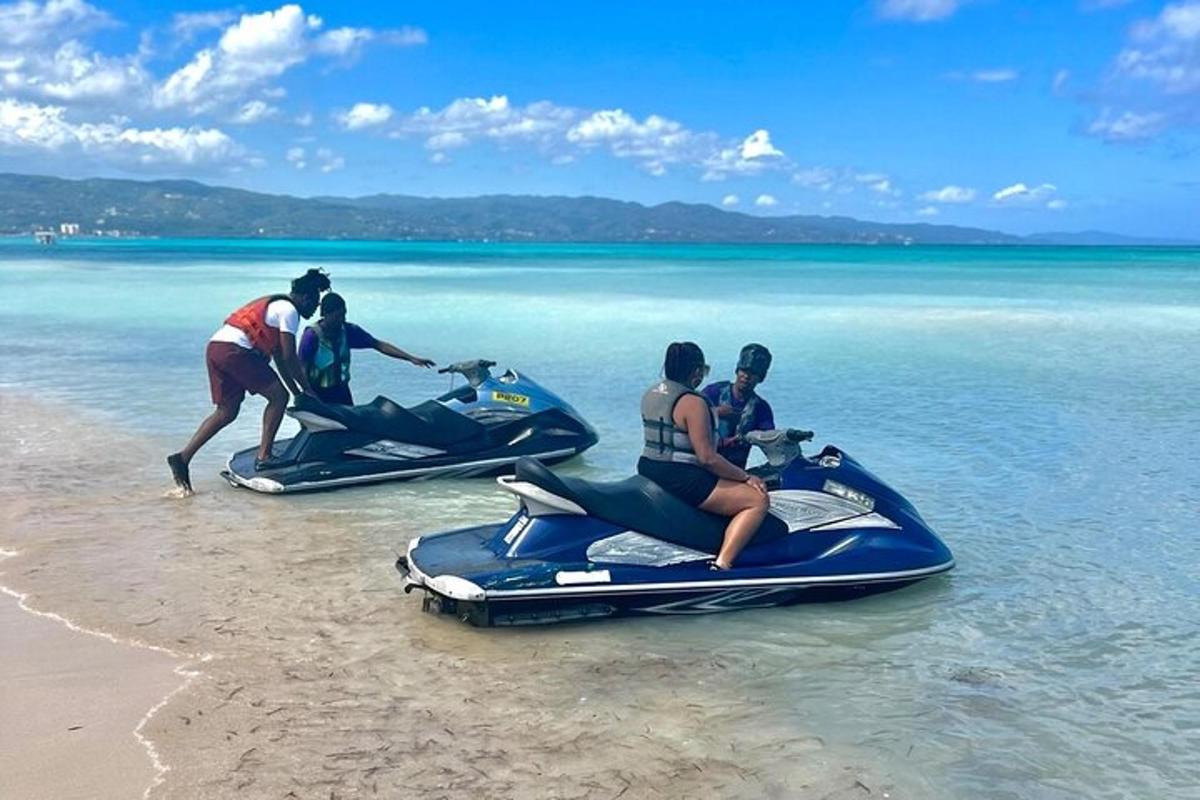 um grupo de pessoas andando de jet ski na praia