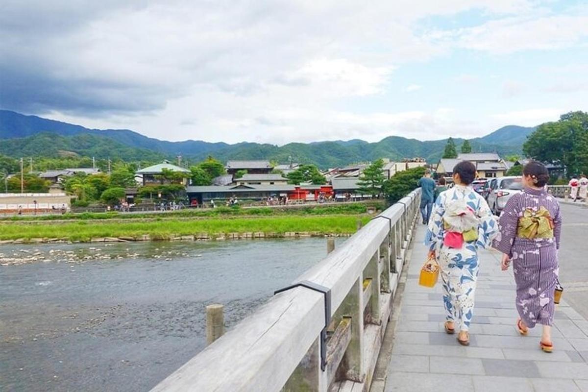 two women walking on a bridge over a river