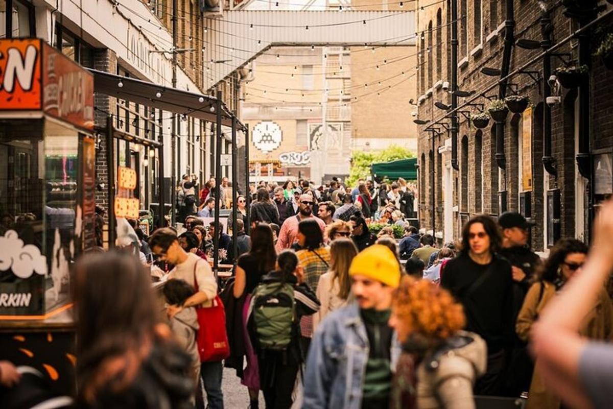 una folla di persone che camminano lungo una strada trafficata