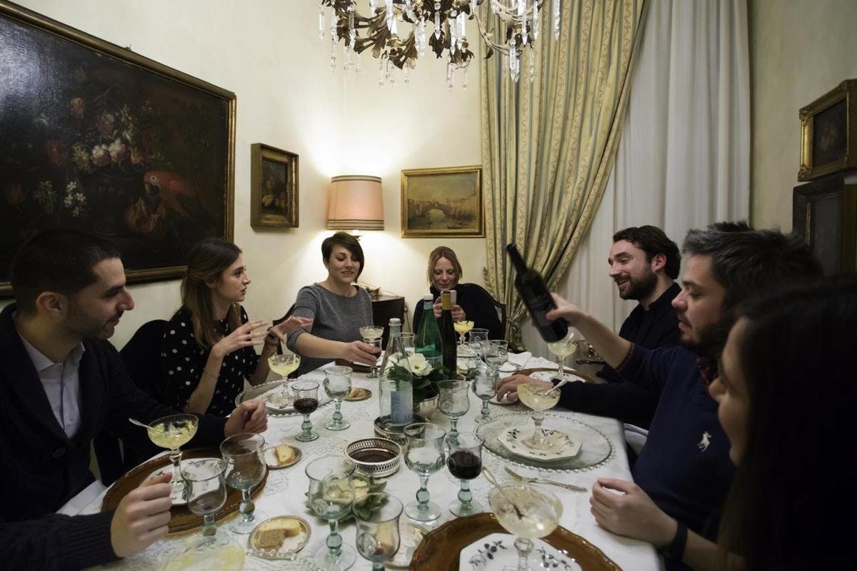 μια ομάδα ανθρώπων που κάθονται γύρω από ένα τραπέζι