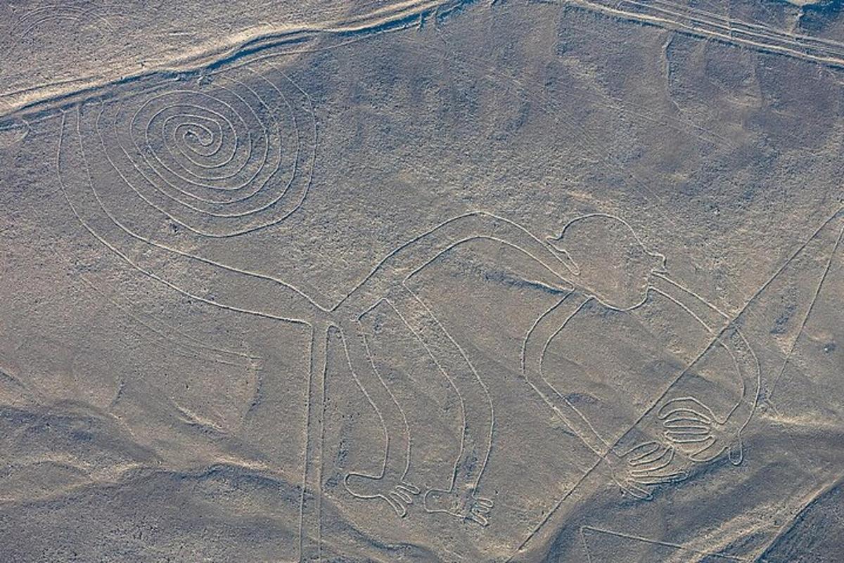 a rock painting of a man sitting in a chair