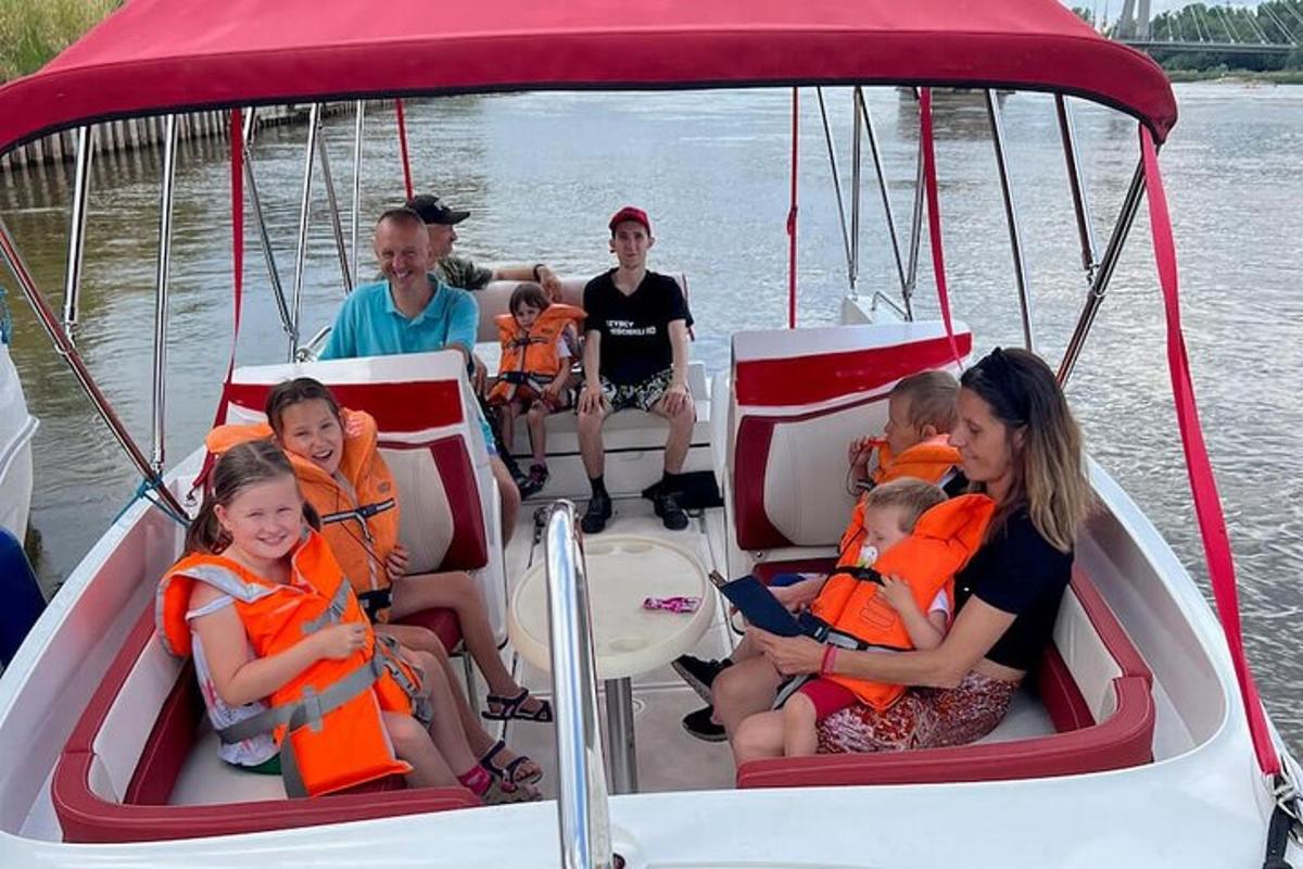 a group of people sitting on a boat on the water
