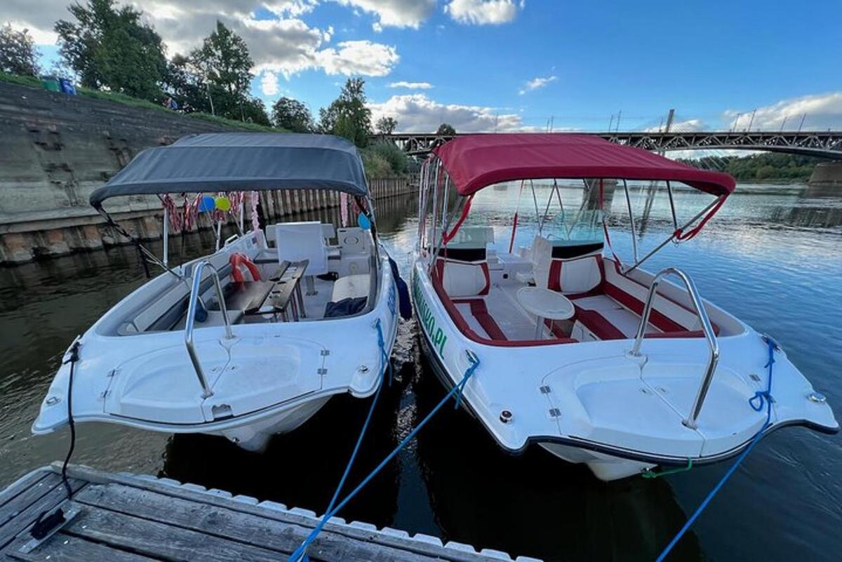two boats are docked at a dock in the water
