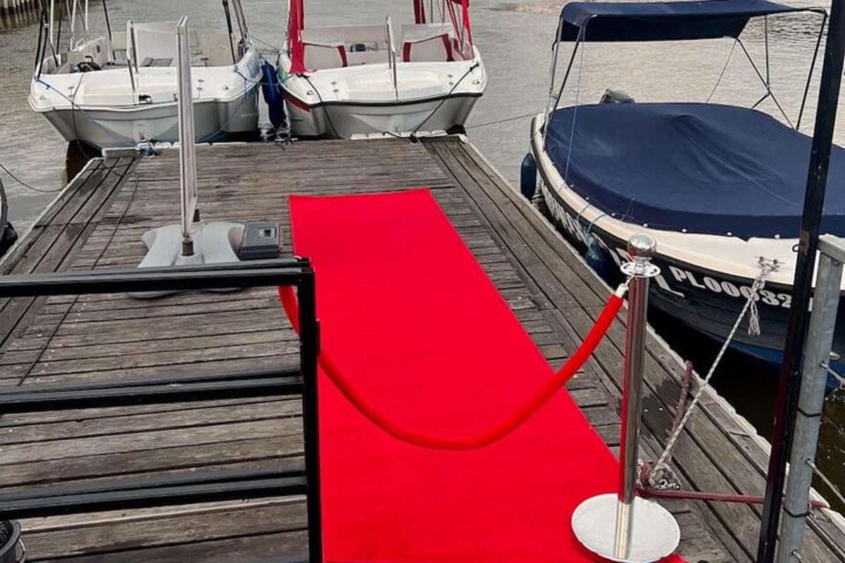 a red carpet on a dock with two boats