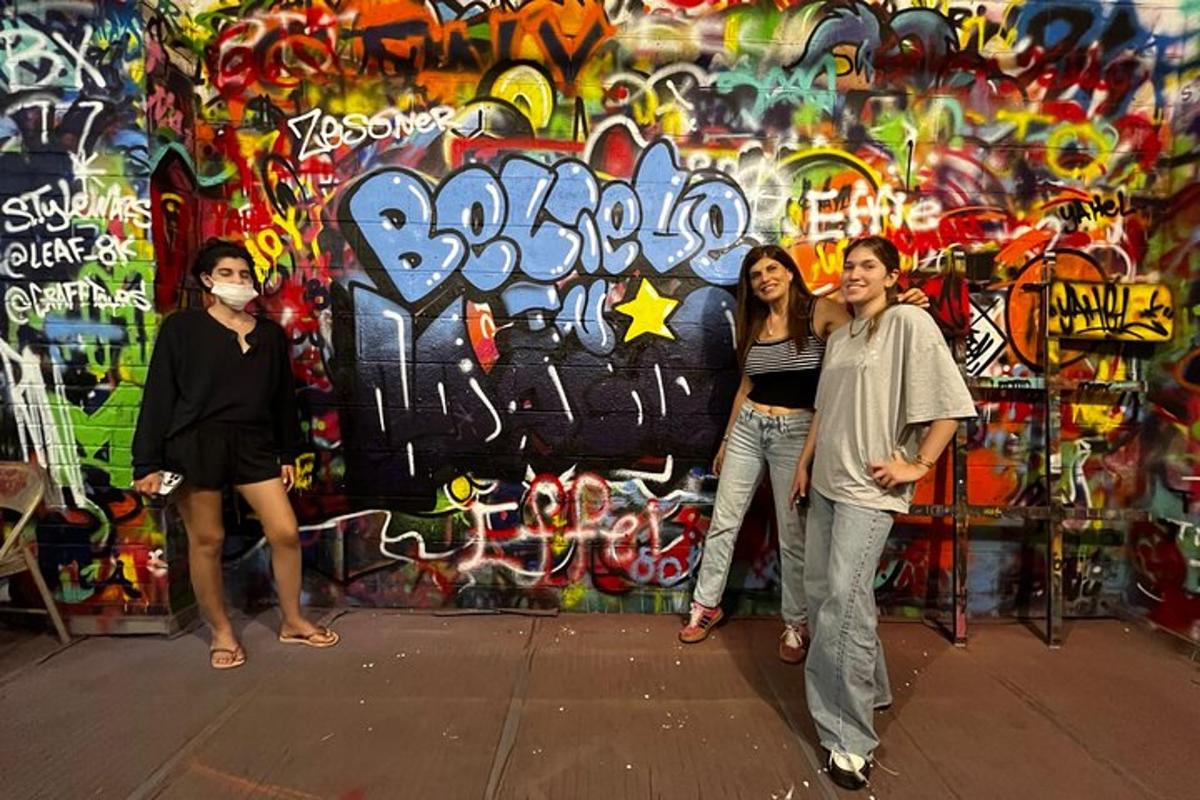 a group of people standing in front of a wall with graffiti