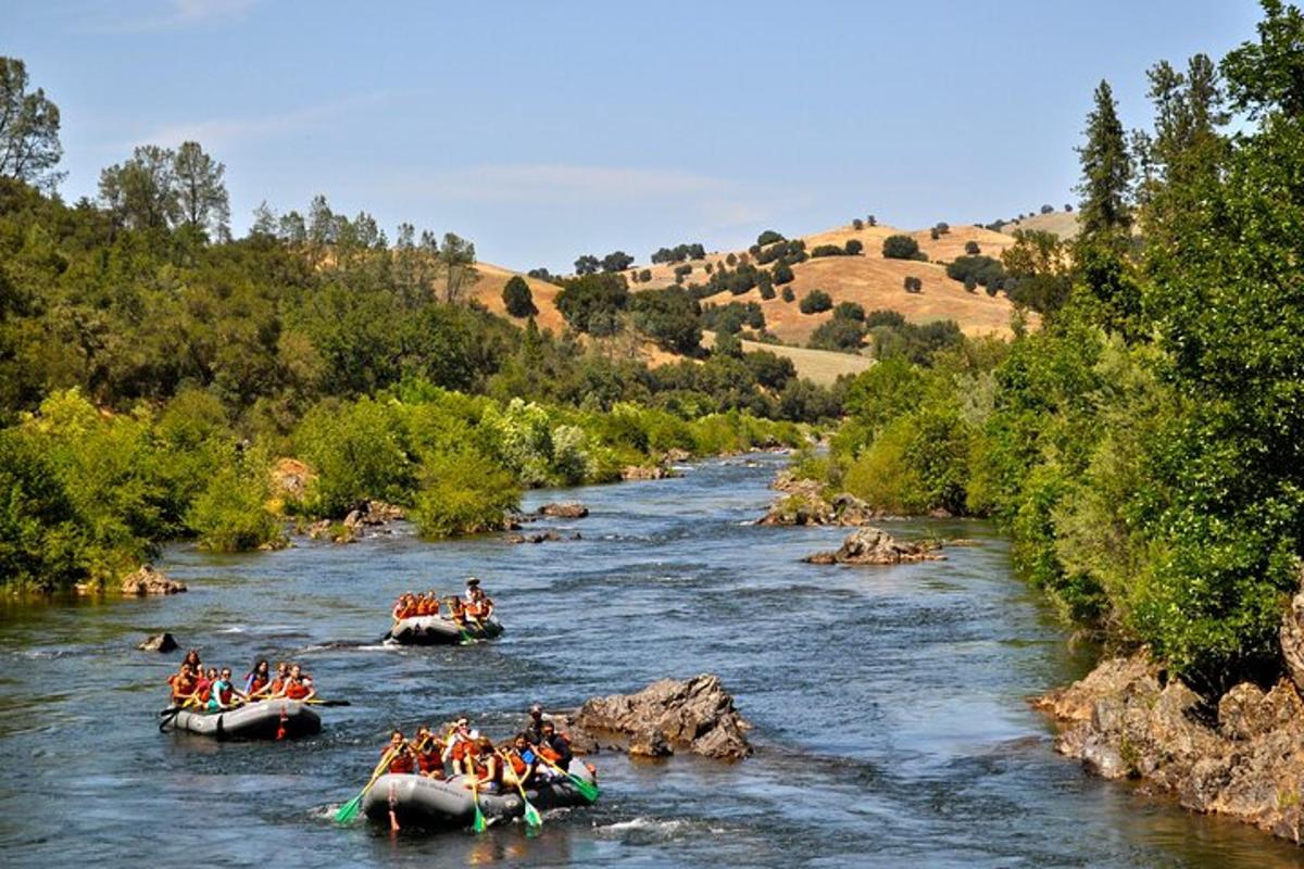 a group of people rafting down a river