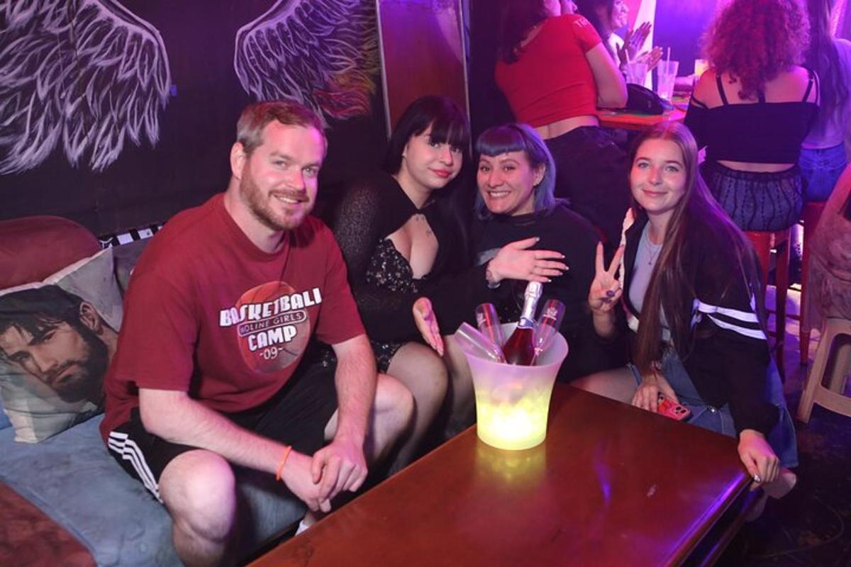 a group of people sitting around a table in a bar